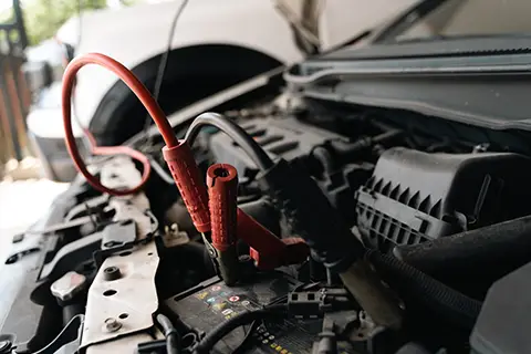 Mobile jumpstart service Dublin — technician jumpstarting car at home driveway